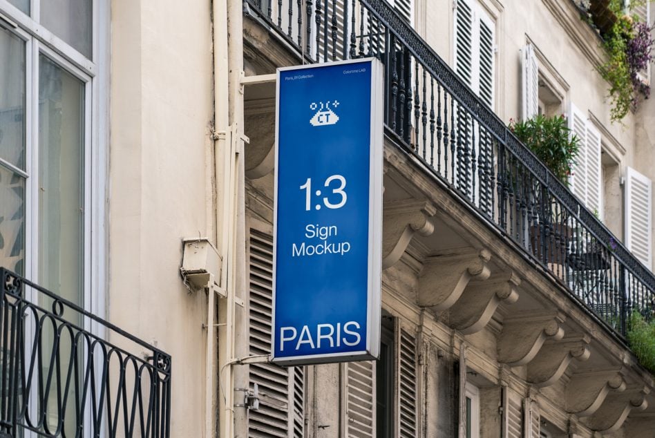 Blue vertical sign hanging on Parisian building facade showing 1:3 ratio mockup
